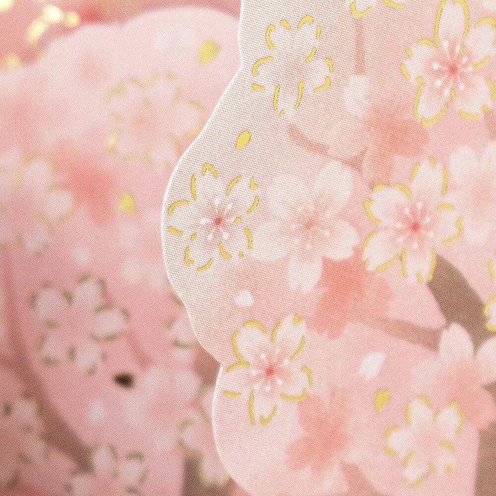 Close-up of gold foil cherry blossoms and Shiba Inu dog details on the 3D pop-up card