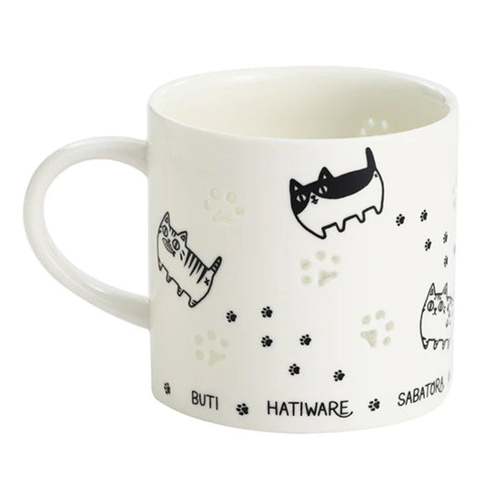 Porcelain carved mug showing paw glow effect and cat illustrations