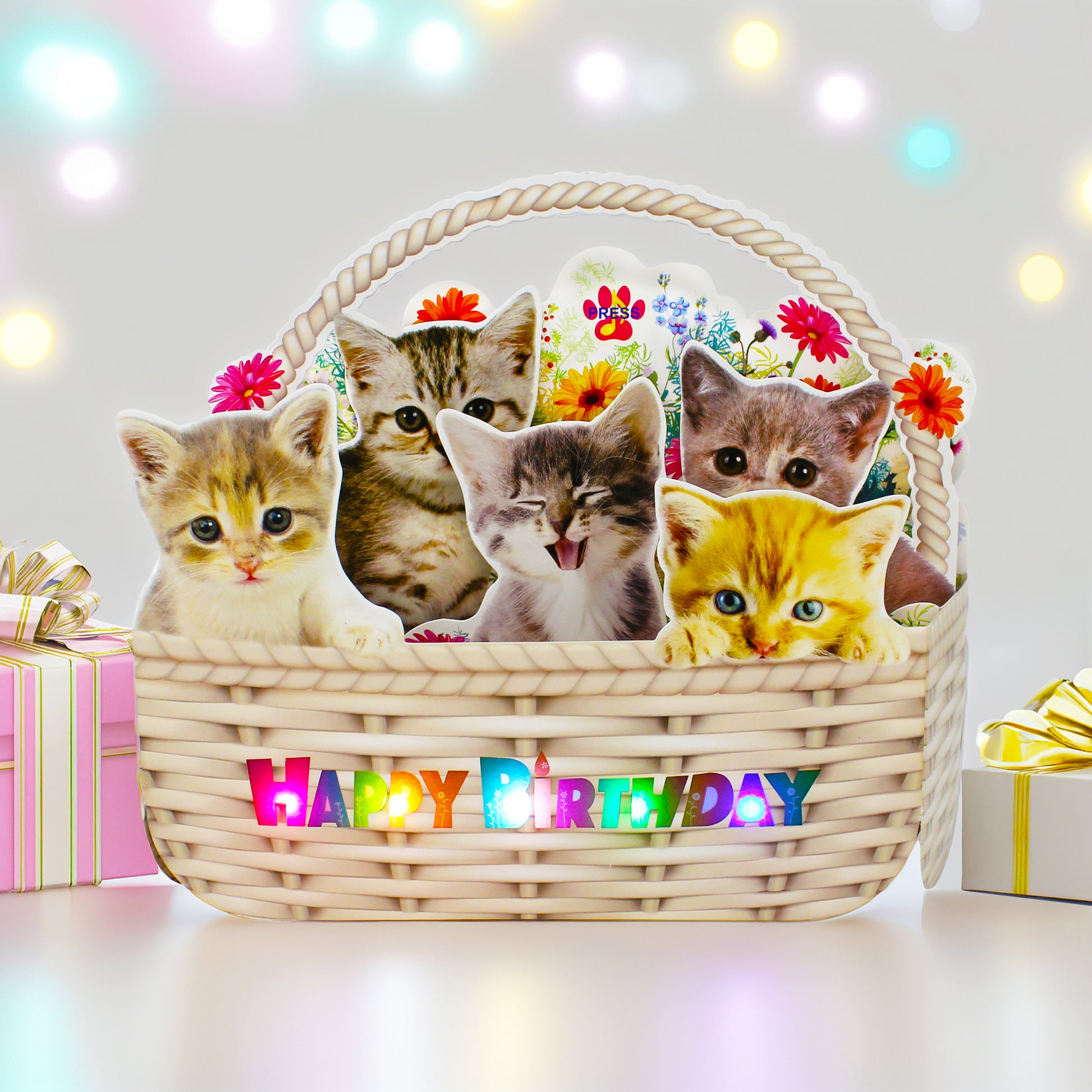 Kitten birthday card on dining table with gift boxes