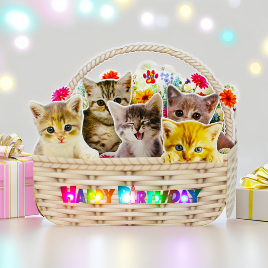 Kitten birthday card on dining table with gift boxes