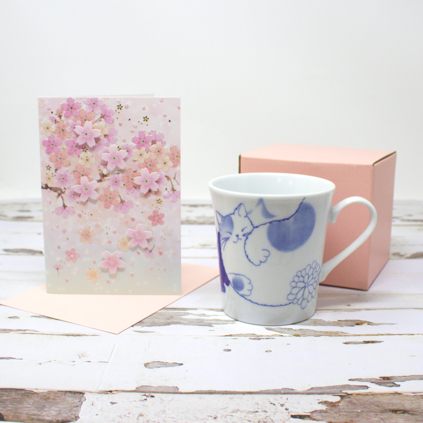 Japanese Nohohon Cat Mug and Cherry Blossom Card Gift Set – Mugi (Walking Cat) or Sora (Laying Cat) – Porcelain mug with black cat design and elegant sakura greeting card, perfect for cat lovers or Mother’s Day gift.