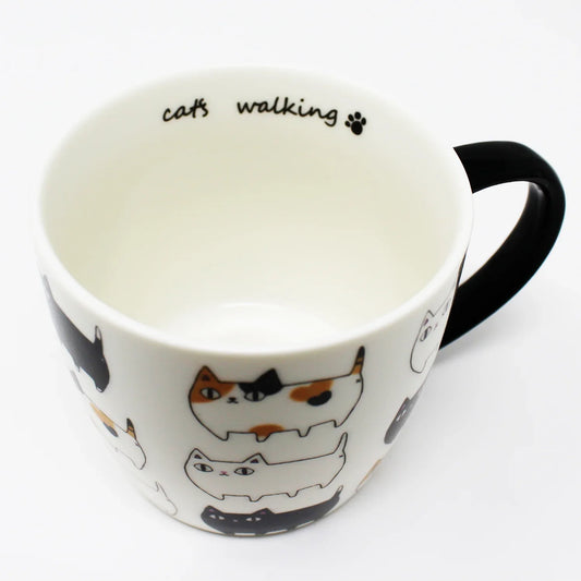 3 Cat Brothers Cat Parade Mug – White porcelain mug featuring Kuro, Shiro, and Mike marching around in a continuous pattern, with a black paw print inside and black handle – Nyan-ya Series from Japan