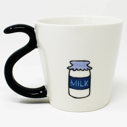Porcelain mug featuring Mike the calico cat from the Nyan-ya series, shown laying down with a black tail-shaped handle, milk artwork, and a bottom graphic of all three cat brothers, in pink gift box.