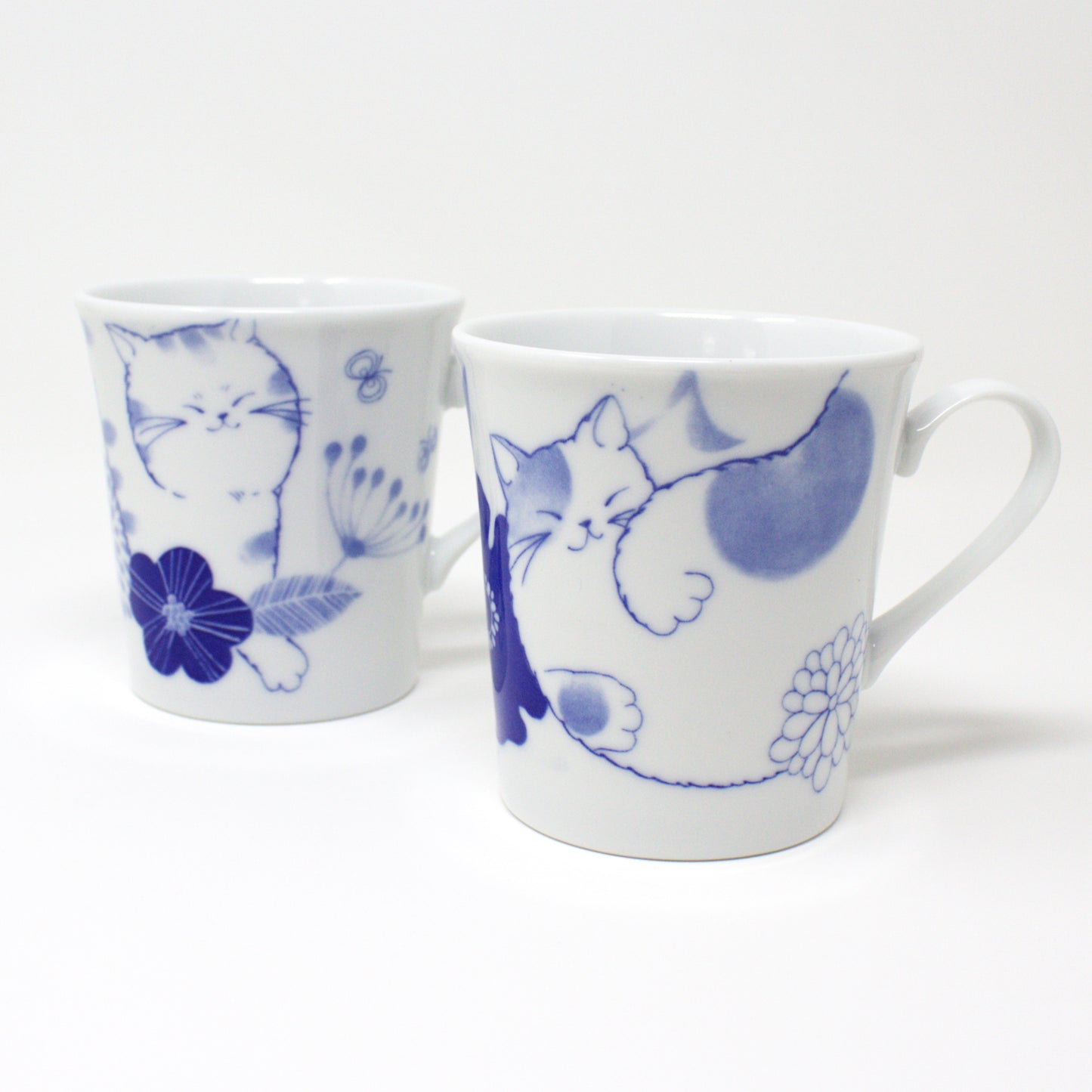 Japanese Nohohon Cat Porcelain Mug featuring Mugi and Sora with relaxed cat designs in blue and white.