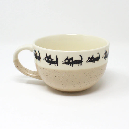 Side view of cat-themed porcelain soup cup – beige with black cats and white interior