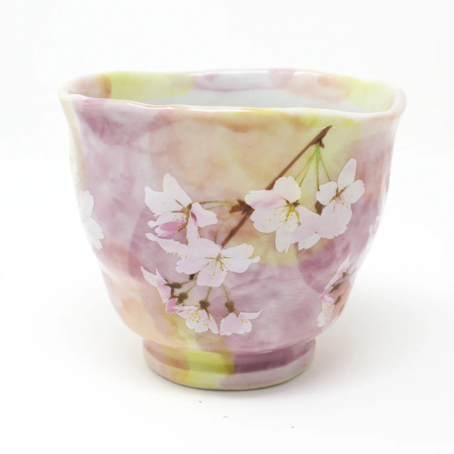 Side view of Hanagasumi Mino Ware Yunomi teacup featuring soft pink and yellow hues with delicate cherry blossom branches, made in Japan.