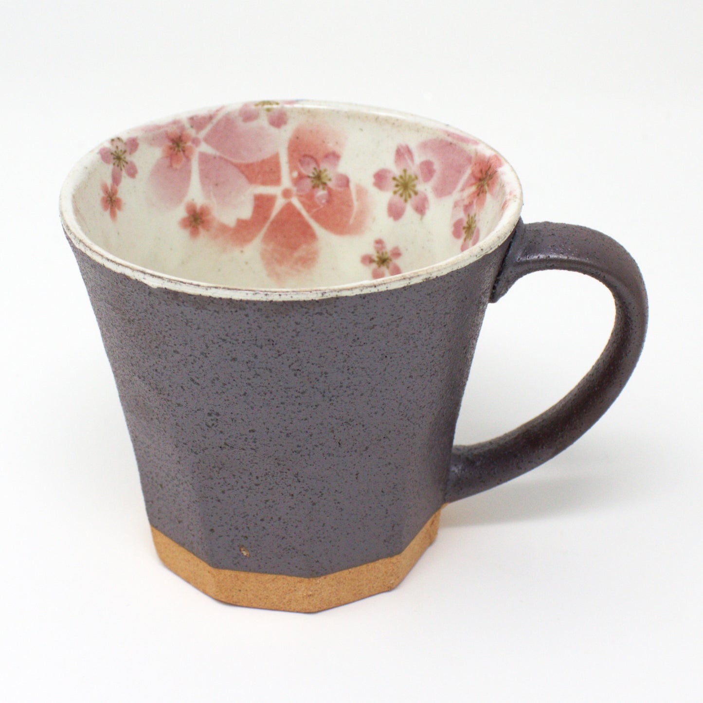 Gray Japanese Mino Ware mug with pink cherry blossom design, handcrafted and glazed, sitting next to its elegant gift box.
