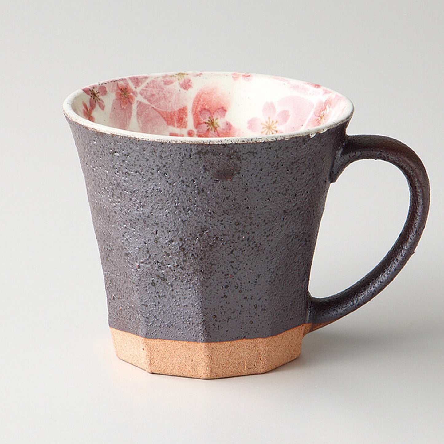 Gray Japanese Mino Ware mug with pink cherry blossom design, handcrafted and glazed, sitting next to its elegant gift box.