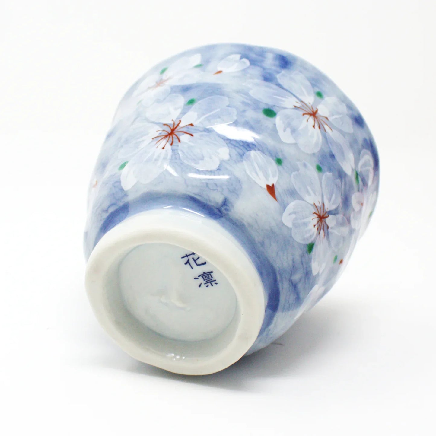 Yayoihana Mino Ware Yunomi Teacup – Blue Cherry Blossom Japanese Porcelain Cup, handcrafted in Japan, featuring a pale blue surface adorned with delicate white cherry blossom flowers, perfect for tea lovers and collectors of Japanese art.