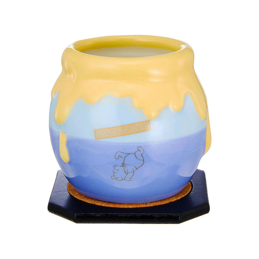 Ceramic mug with Disney Winnie the Pooh blue and yellow design on a white background