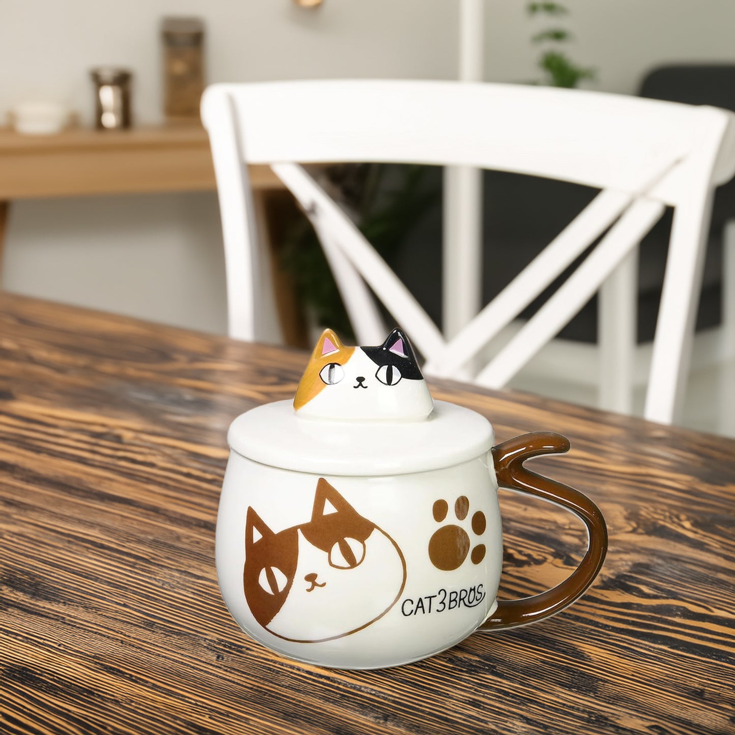Cat-themed mug with a lid on a wooden table