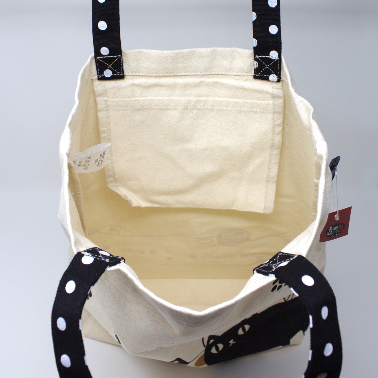 Interior of 3 Cat Brothers tote bag with open inner pocket, showcasing spacious and functional design