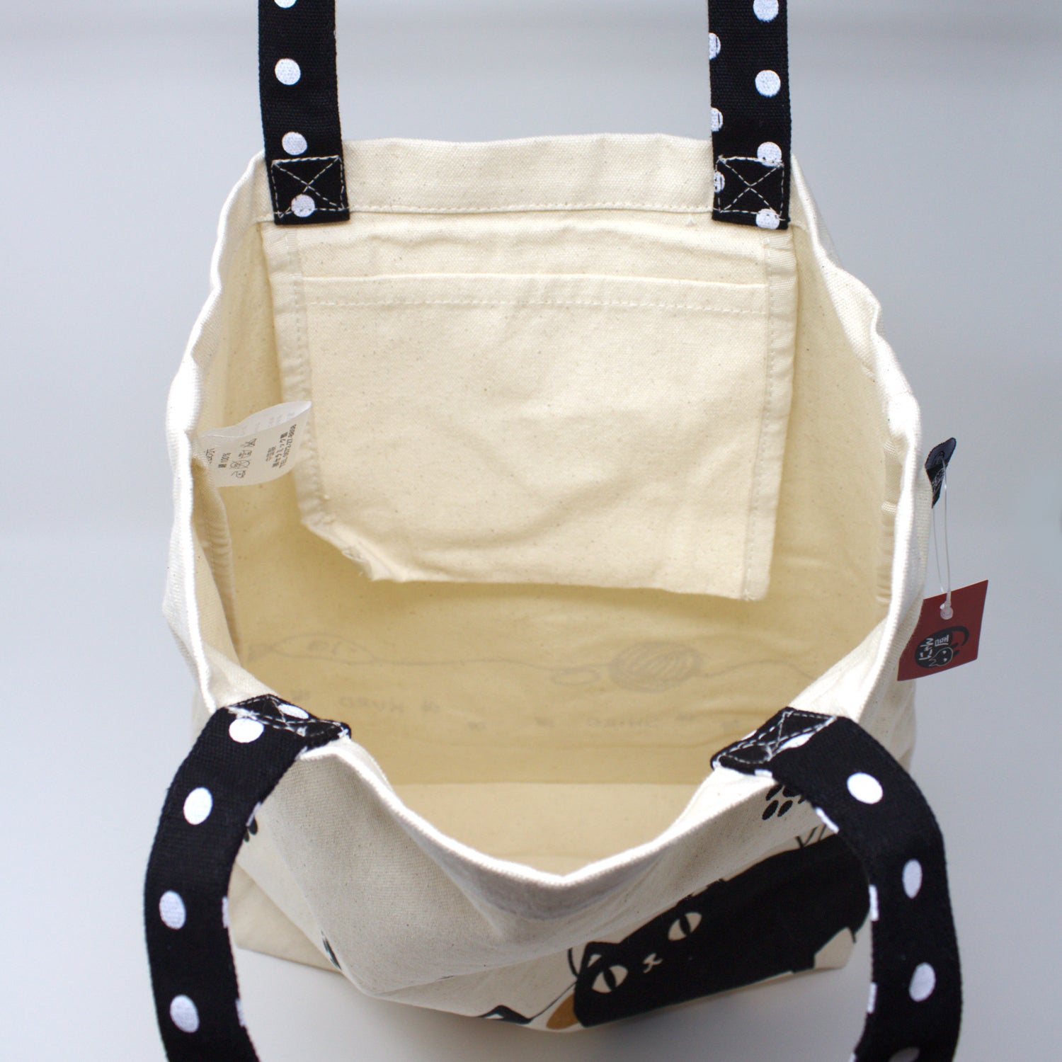Interior of 3 Cat Brothers tote bag with open inner pocket, showcasing spacious and functional design