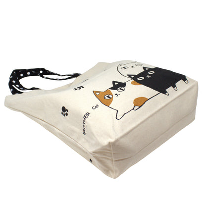 Model carrying 3 Cat Brothers Nyan-ya canvas tote bag to show size and everyday use