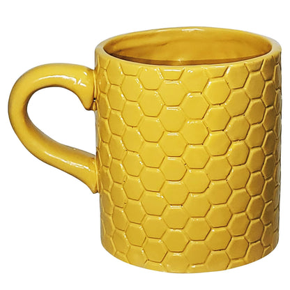Back view of Disney Winnie the Pooh yellow porcelain mug by SUNART showing raised honeycomb texture and curved handle