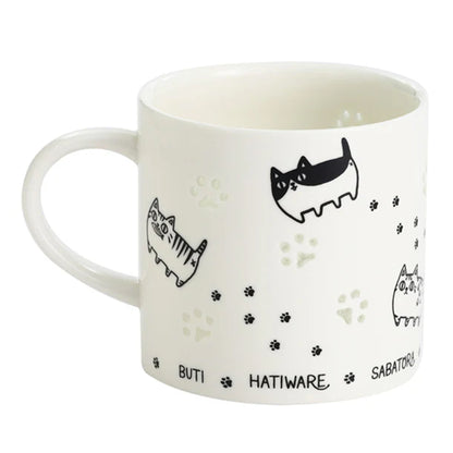 Porcelain carved mug showing paw glow effect and cat illustrations