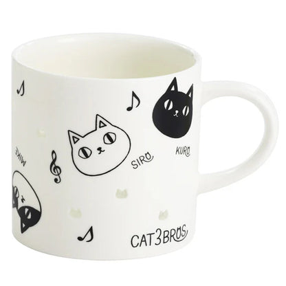 White mug with black cat illustrations and text on a white background