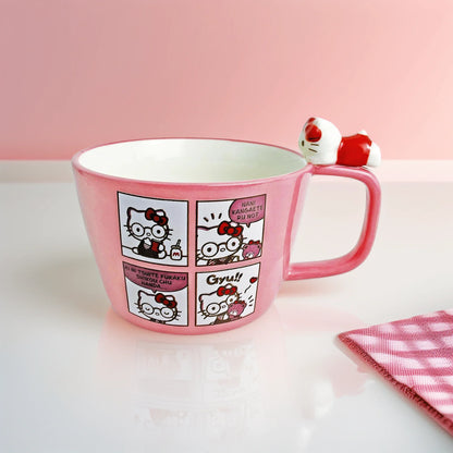 Pink mug with Hello Kitty character design on a white surface with a pink background