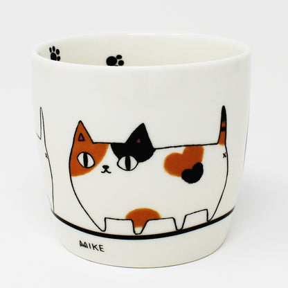 White porcelain mug with black handle and marching cat illustration – 3 Cat Brothers: Kuro, Shiro, Mile