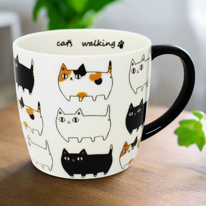 3 Cat Brothers Cat Parade Mug – White porcelain mug featuring Kuro, Shiro, and Mike marching around in a continuous pattern, with a black paw print inside and black handle – Nyan-ya Series from Japan