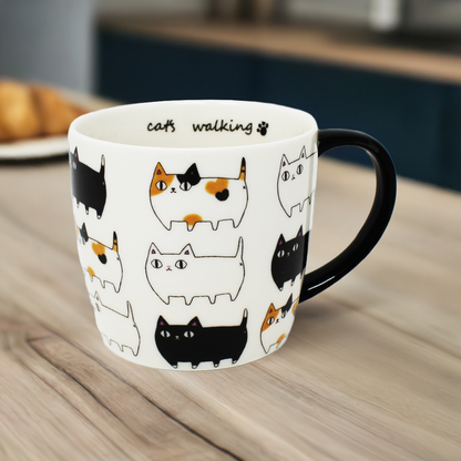 3 Cat Brothers Cat Parade Mug – White porcelain mug featuring Kuro, Shiro, and Mike marching around in a continuous pattern, with a black paw print inside and black handle – Nyan-ya Series from Japan