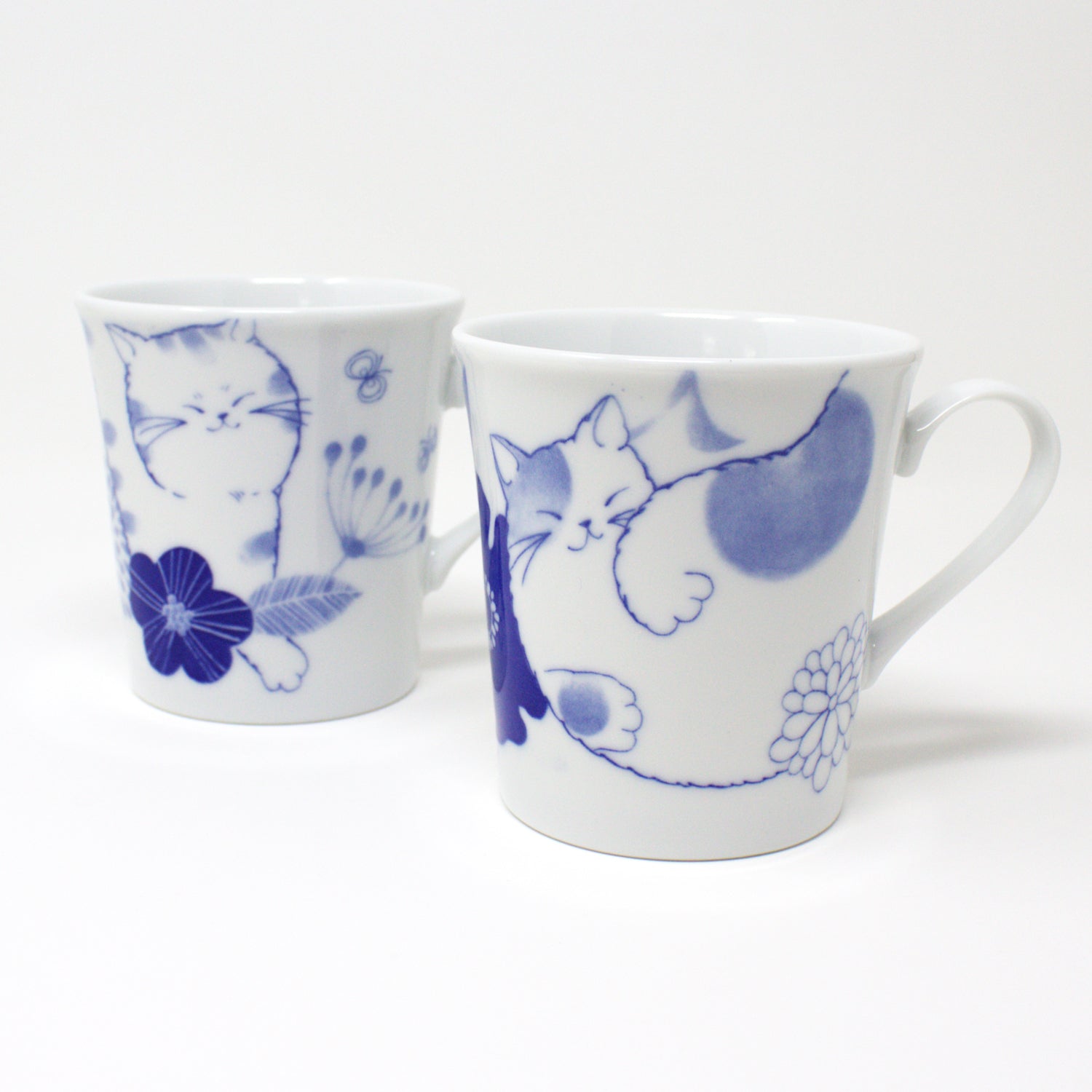 Japanese Nohohon Cat Porcelain Mug featuring Mugi and Sora with relaxed cat designs in blue and white.