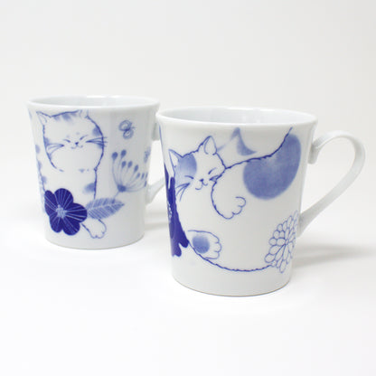 Japanese Nohohon Cat Porcelain Mug featuring Mugi and Sora with relaxed cat designs in blue and white.