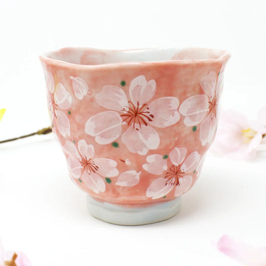 Side view of Yayoihana Mino Ware Yunomi Teacup in soft pink with white cherry blossom flowers, handcrafted in Japan