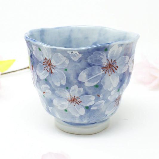 Yayoihana Mino Ware Yunomi Teacup – Blue Cherry Blossom Japanese Porcelain Cup, handcrafted in Japan, featuring a pale blue surface adorned with delicate white cherry blossom flowers, perfect for tea lovers and collectors of Japanese art.