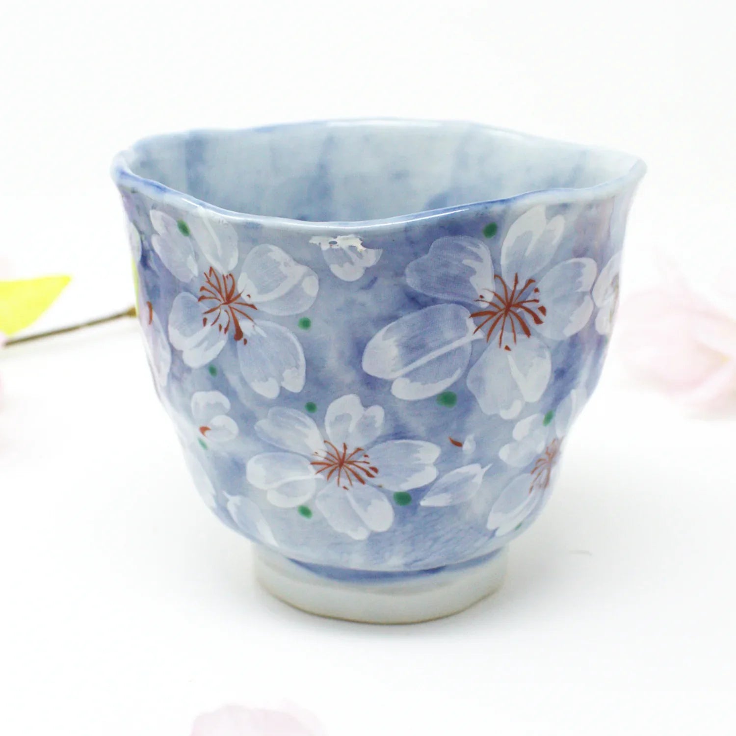 Yayoihana Mino Ware Yunomi Teacup – Blue Cherry Blossom Japanese Porcelain Cup, handcrafted in Japan, featuring a pale blue surface adorned with delicate white cherry blossom flowers, perfect for tea lovers and collectors of Japanese art.