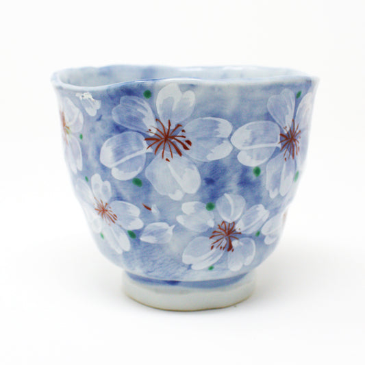 Yayoihana Mino Ware Yunomi Teacup – Blue Cherry Blossom Japanese Porcelain Cup, handcrafted in Japan, featuring a pale blue surface adorned with delicate white cherry blossom flowers, perfect for tea lovers and collectors of Japanese art.