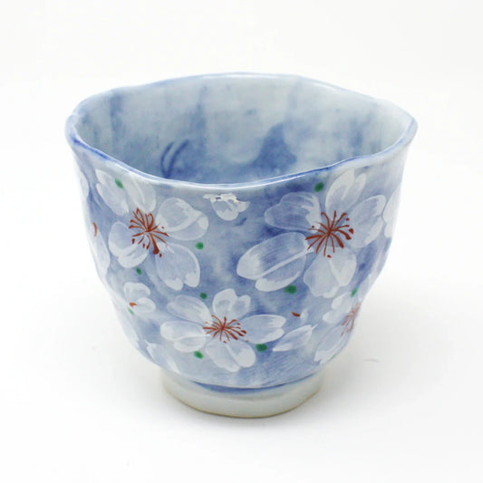Yayoihana Mino Ware Yunomi Teacup – Blue Cherry Blossom Japanese Porcelain Cup, handcrafted in Japan, featuring a pale blue surface adorned with delicate white cherry blossom flowers, perfect for tea lovers and collectors of Japanese art.