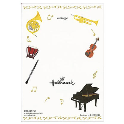 Notepad with musical instrument illustrations and Hallmark logo on a white background