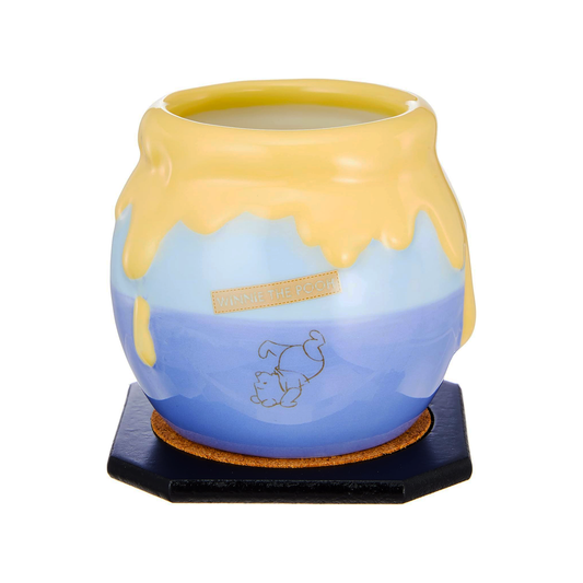 Ceramic mug with Disney Winnie the Pooh blue and yellow design on a white background