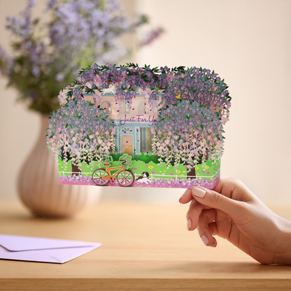 Wisteria 3D pop up greeting card held in hand with matching light purple envelope